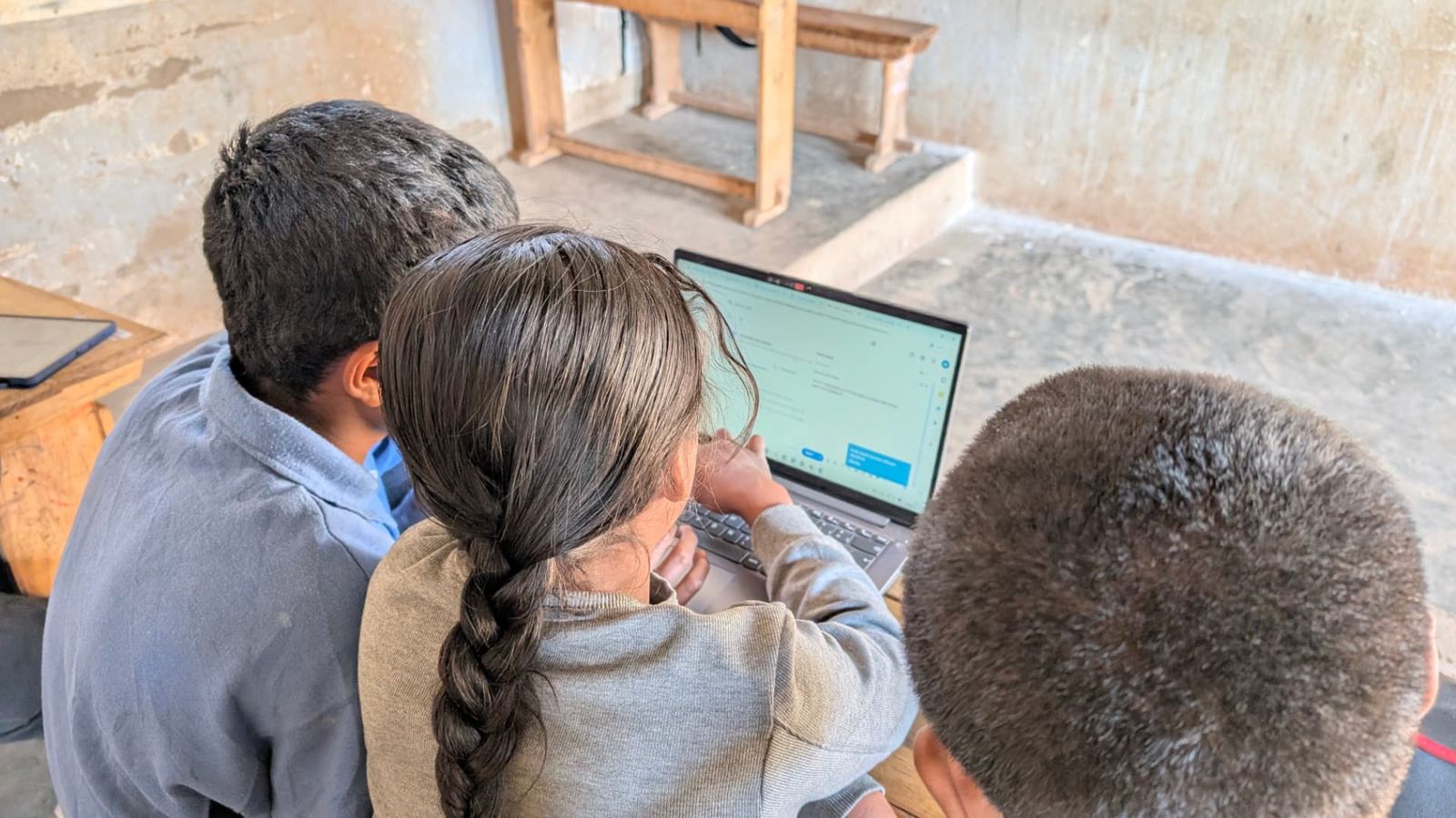 Students working together on an online form, 2025