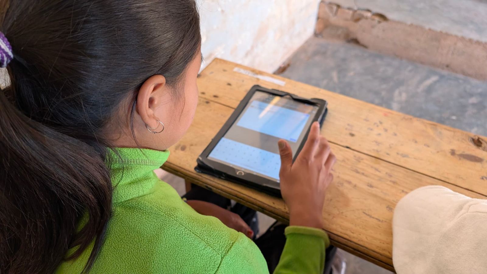 A student typing on a tablet during a 2025 session