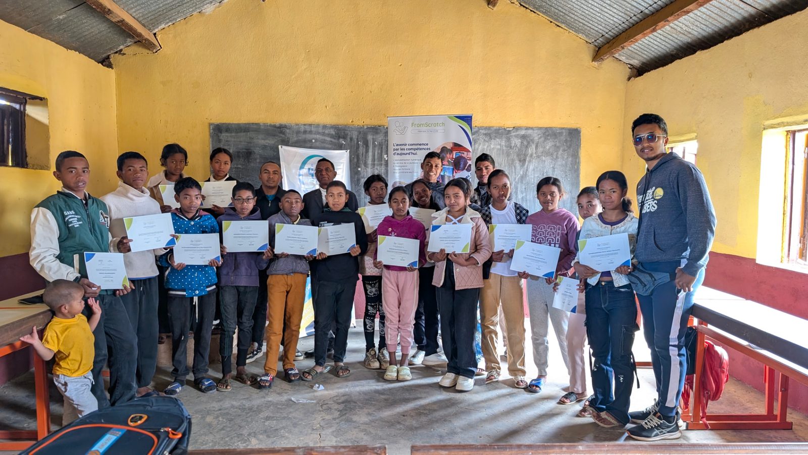 The 2026 cohort holding their certificates with trainers and partners