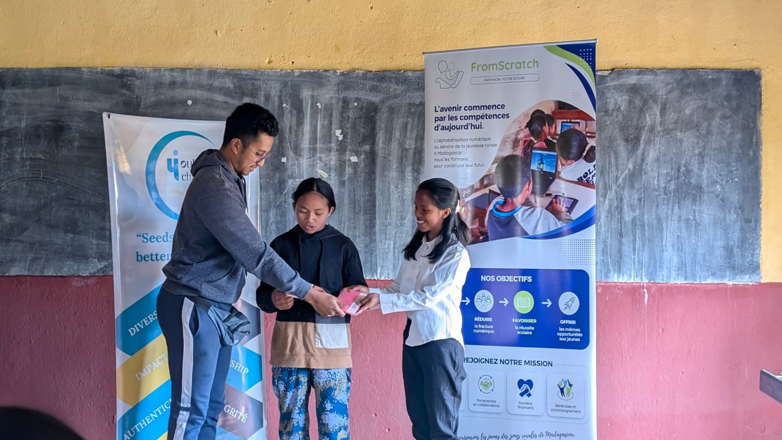 A trainer handing an award to a student at the 2026 closing ceremony