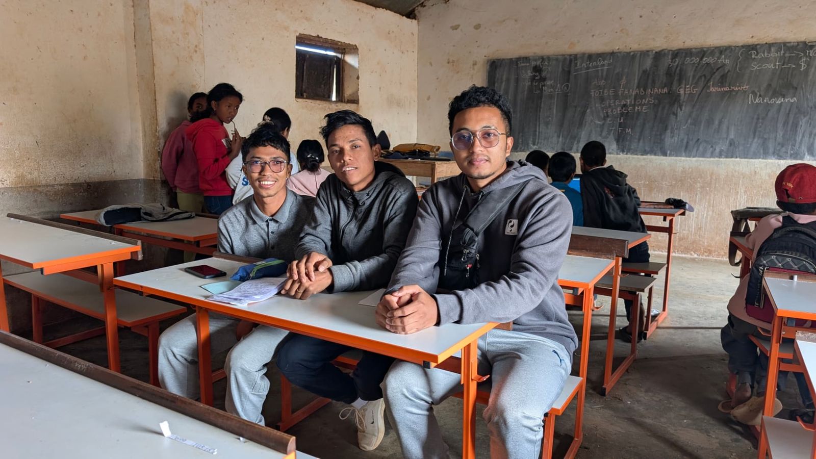 Three FromScratch trainers seated in the classroom, 2026